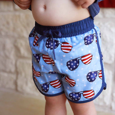 4th of july swim trunks for boys with red, white and blue sunglasses 
