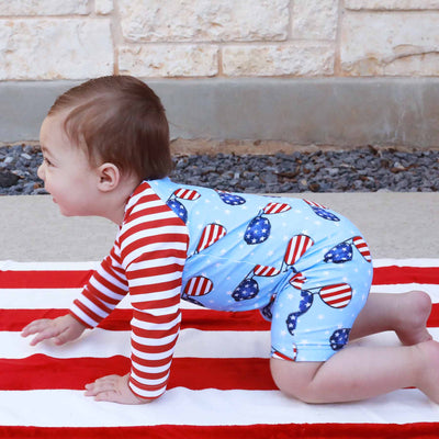 flag swim romper with shorts and long sleeves for babies with sunglasses 
