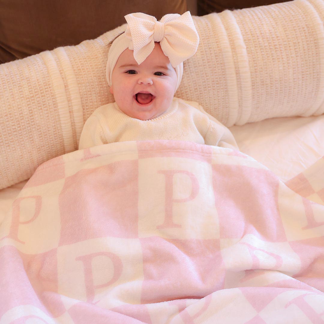 pink checkered print blanket personalized with initial