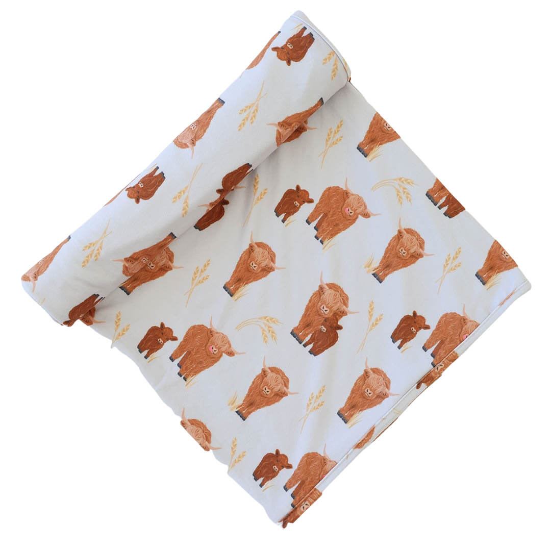 oversized swaddle printed with highland cows