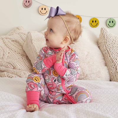 pink pajama romper for babies pink with floaties, disco balls and smiley faces