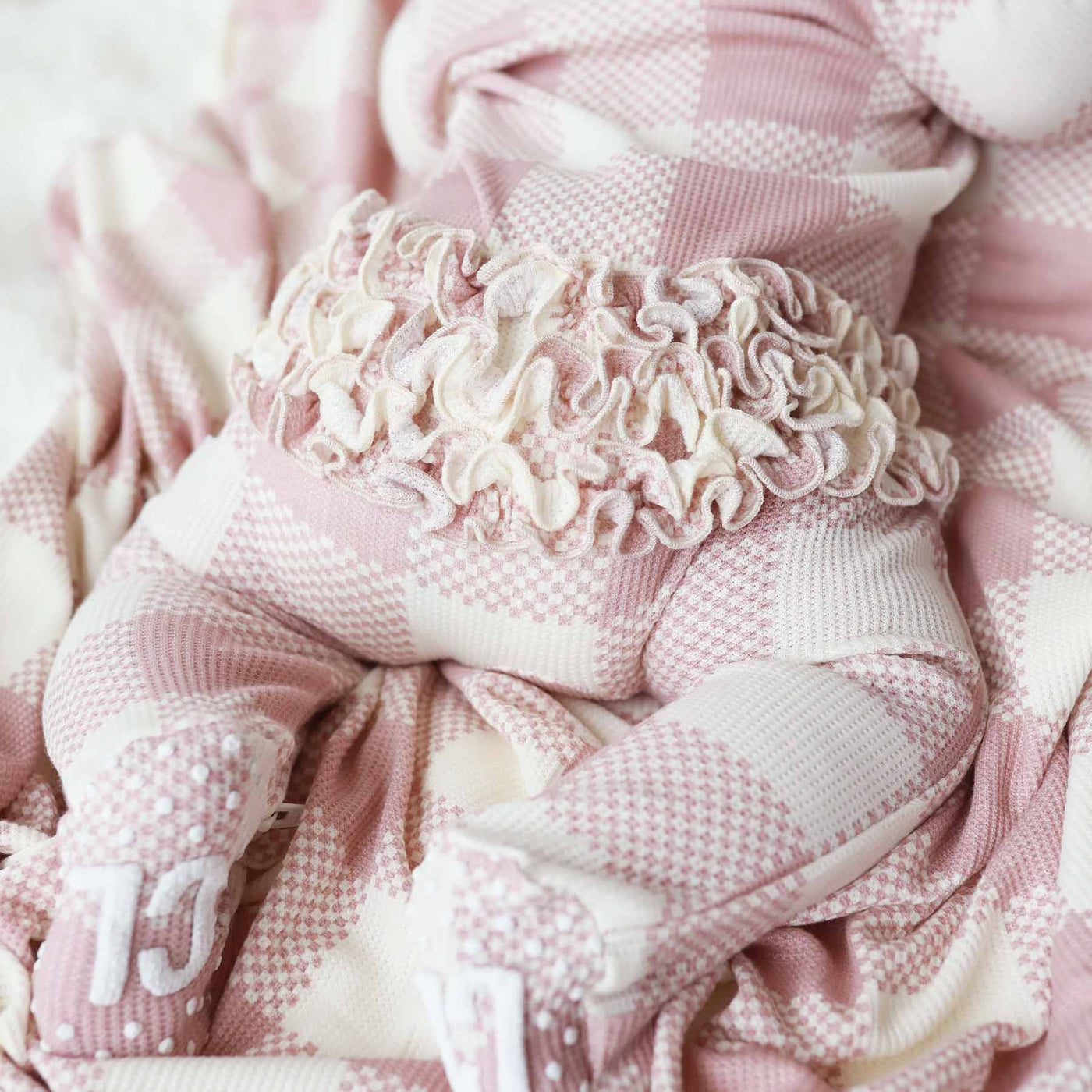 bamboo waffle ruffle butt footie for babies pink check 