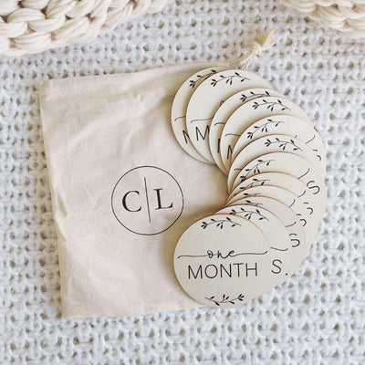 milestone wood circle announcement with months for babies 