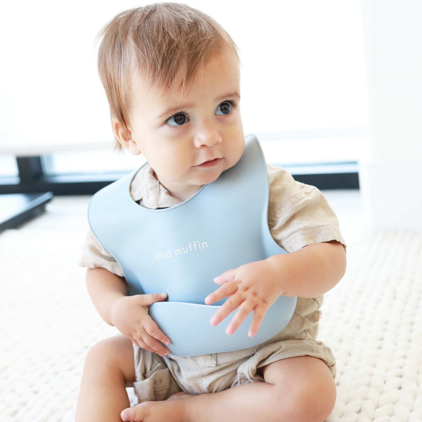 blue baby bib with saying made of silicone 