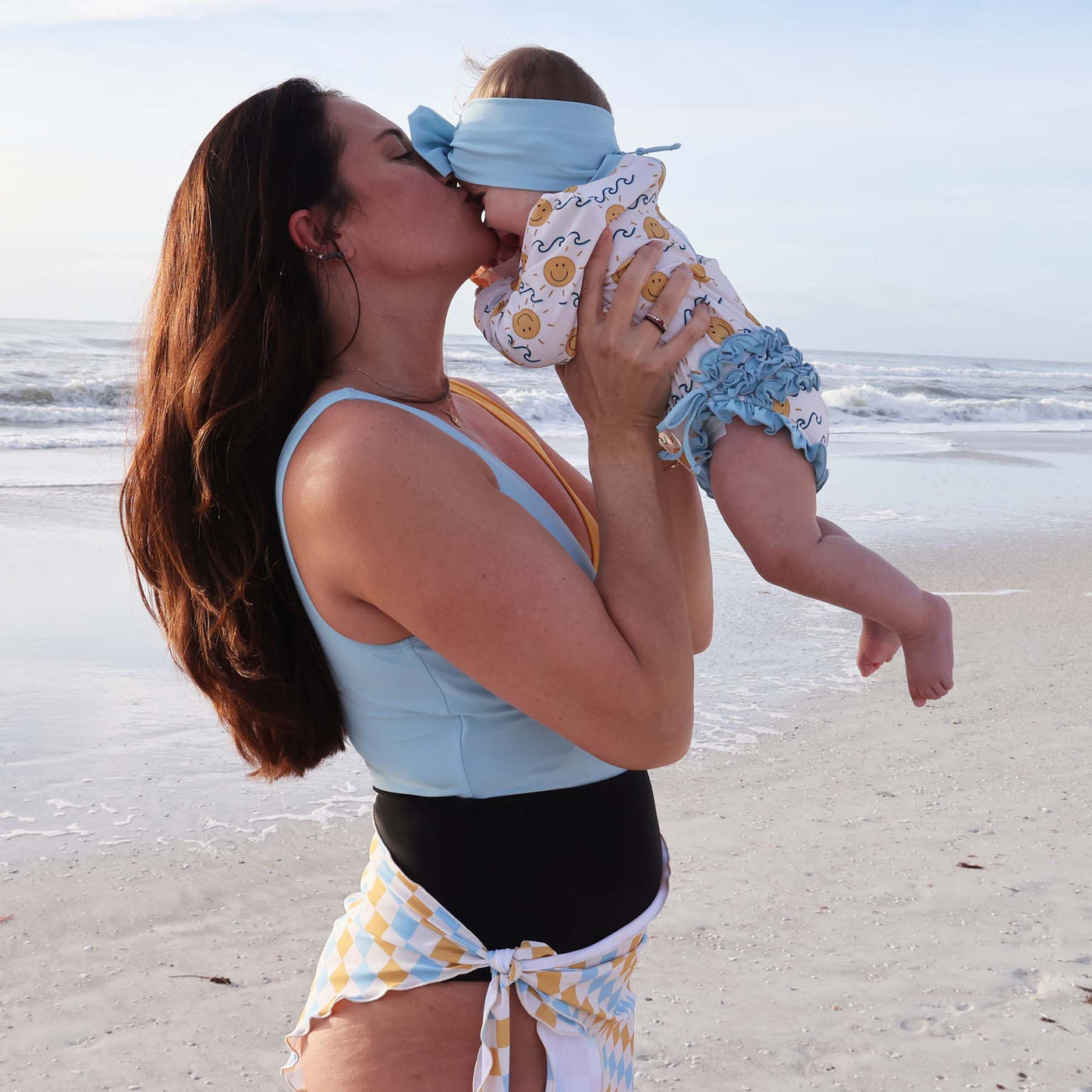 blue waves and yellow sun long sleeve swimsuit romper for toddlers with ruffles on the butt 