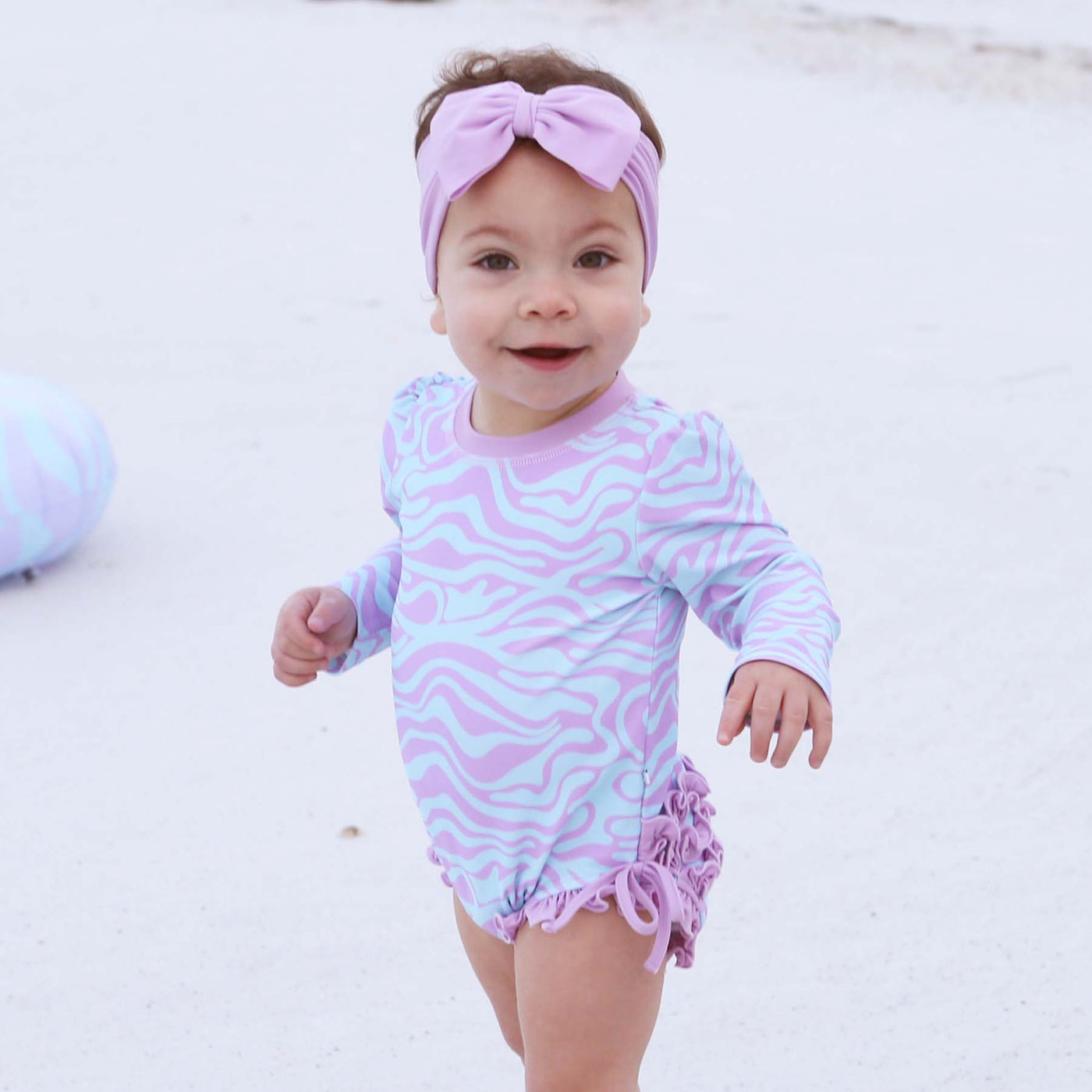blue and purple wavy long sleeve rash guard ruffle bottom swimsuit for babies 