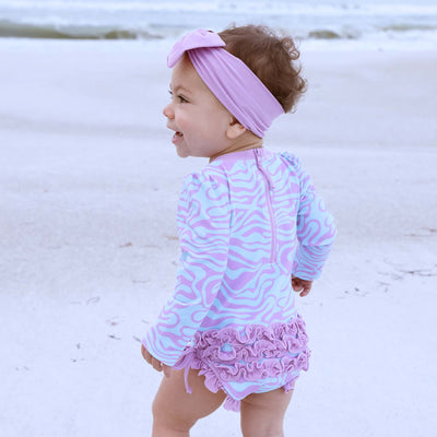 long sleeve rash guard swimsuit for babies with ruffle on the bottom wavy days 