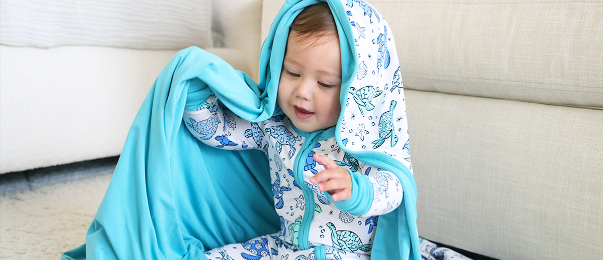 baby wearing Caden Lane bamboo pajamas with sea turtles print