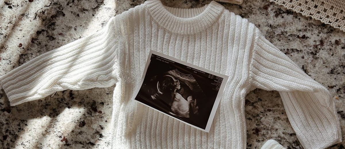 Caden Lane knit sweater with ultrasound picture of baby