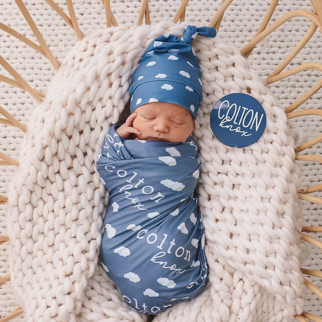 baby wrapped in the sweet dreams personalzied swaddle blanket and wearing a sweet dreams knot hat.