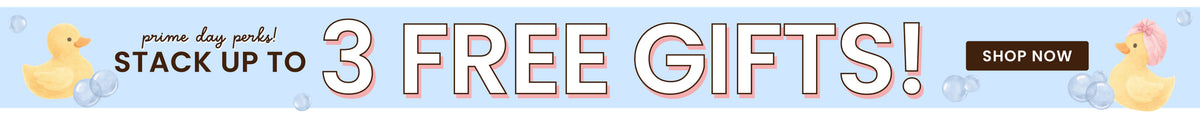 A Caden Lane Prime days promotional banner with the text 'prime day deals! STACK UP TO 3 FREE GIFTS!' in large outlined letters, a dark brown 'SHOP NOW' button, and two small yellow rubber duckies on a pale blue background with faint bubble shapes.