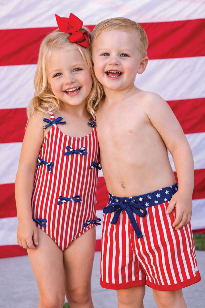 brother and sister in matching 4th of july swimsuits