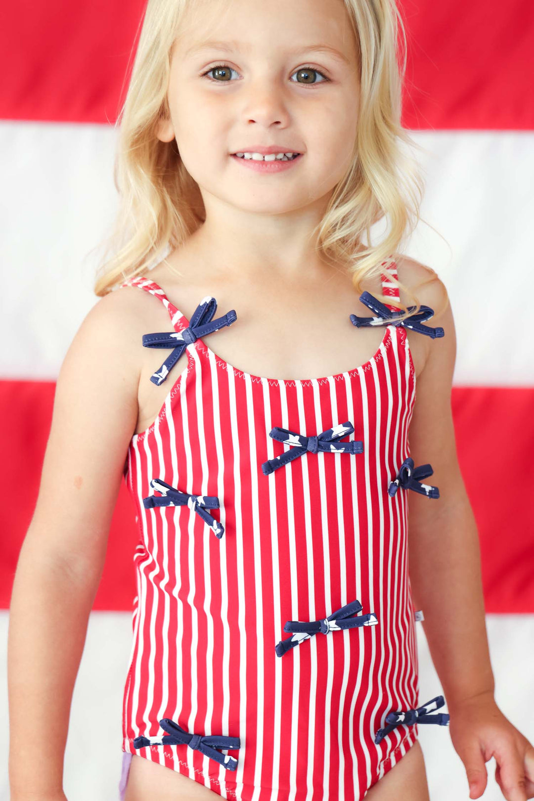 Stars & Stripes Party baby girl one piece swimsuit with tiny bows view 10 | 4th of July swim | Caden Lane