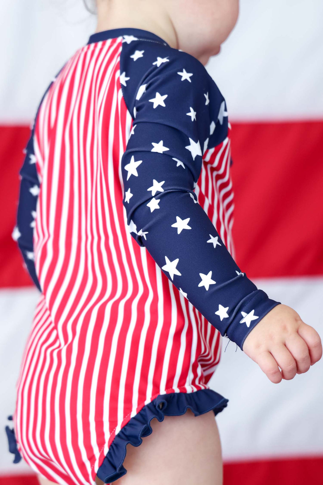 Kids long sleeve rash guard with front zipper flat lay | USA patriotic swim | UPF 50+ kids swimwear | Caden Lane