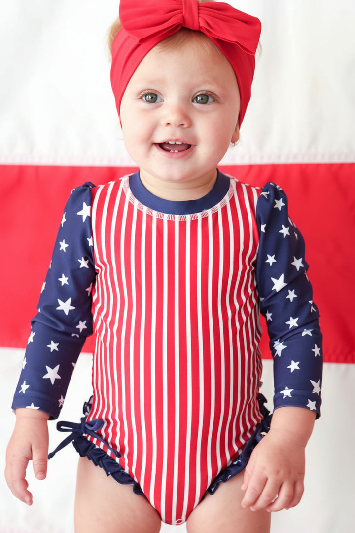 Stars & Stripes Party baby girl rash guard with ruffle bottom detail view 5 | 4th of July kids swim | Caden Lane