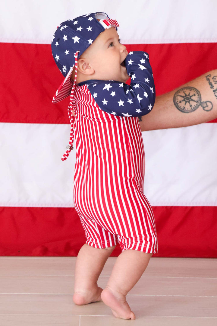 side view of stars  stripes long sleeve swim romper shortie