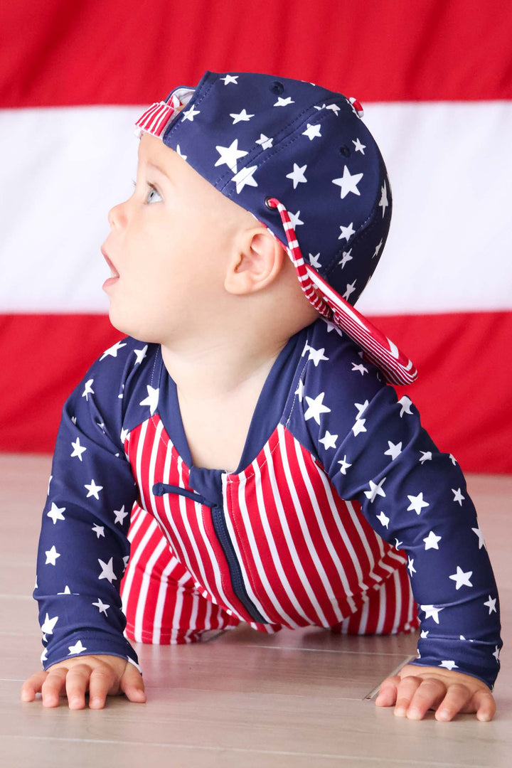 baby boy in american flag swim romper shortie and matching surf hat 