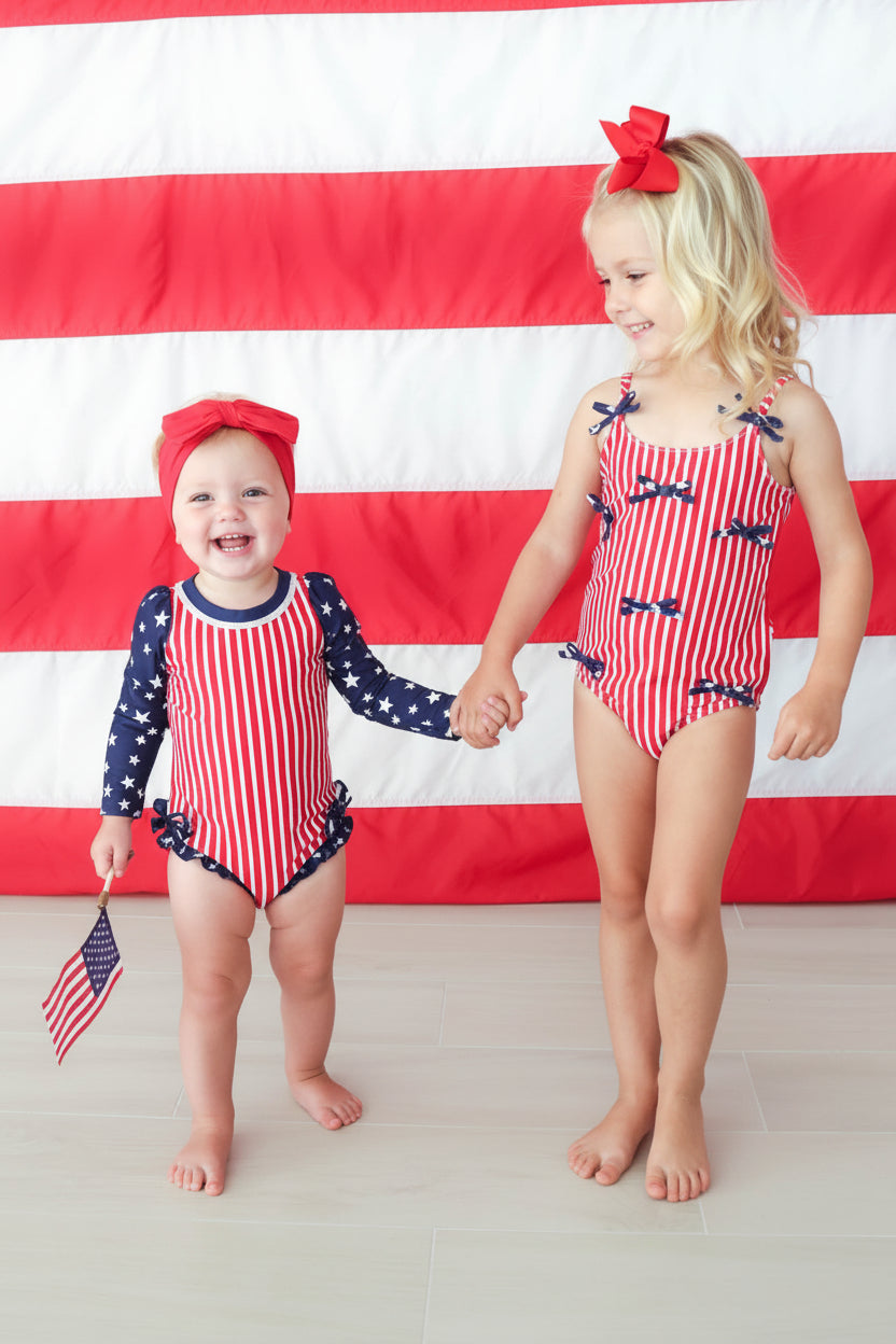 Stars & Stripes Party baby girl rash guard with ruffle bottom detail view 4 | 4th of July kids swim | Caden Lane