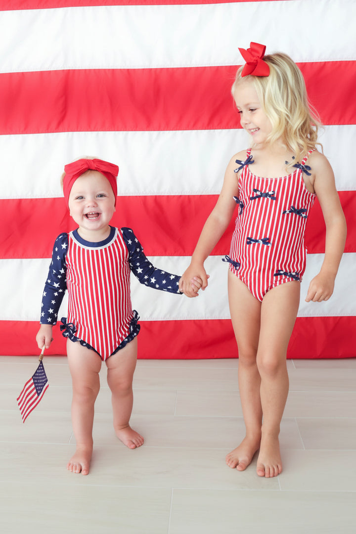Stars & Stripes Party baby girl rash guard with ruffle bottom detail view 4 | 4th of July kids swim | Caden Lane