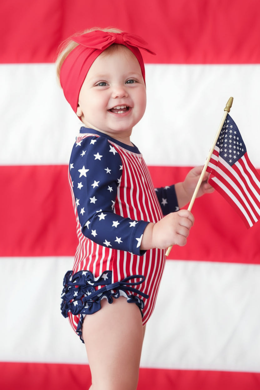 Baby girl rash guard with ruffle bottom | Stars & Stripes Party 4th of July swimwear | UPF 50+ sun protection | Caden Lane