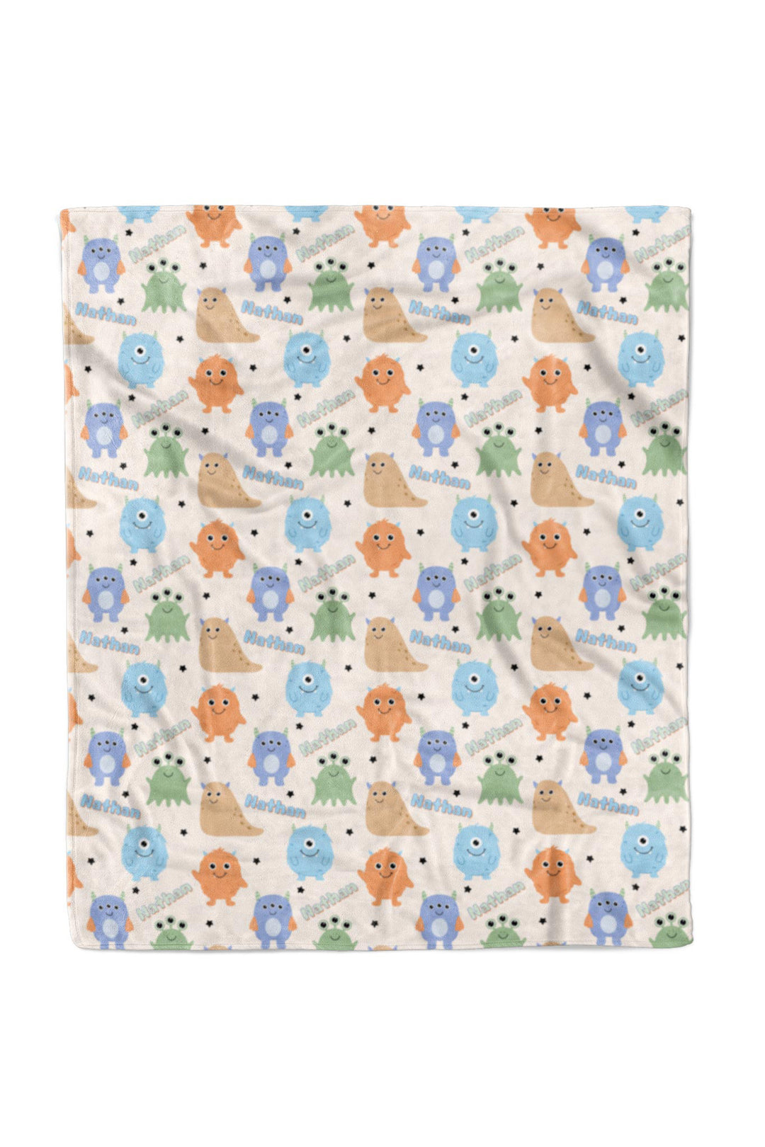 Caden Lane 50x60 personalized "Nathan" minky blanket in Little Monsters print with blue, orange, tan, and green cartoon monsters and stars
