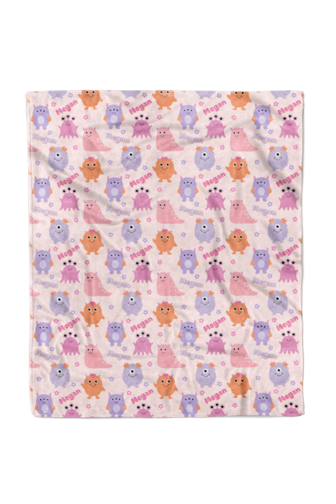 Caden Lane 50x60 personalized "Megan" minky blanket in Little Monsters print with pink, purple, and orange cartoon monsters and flowers