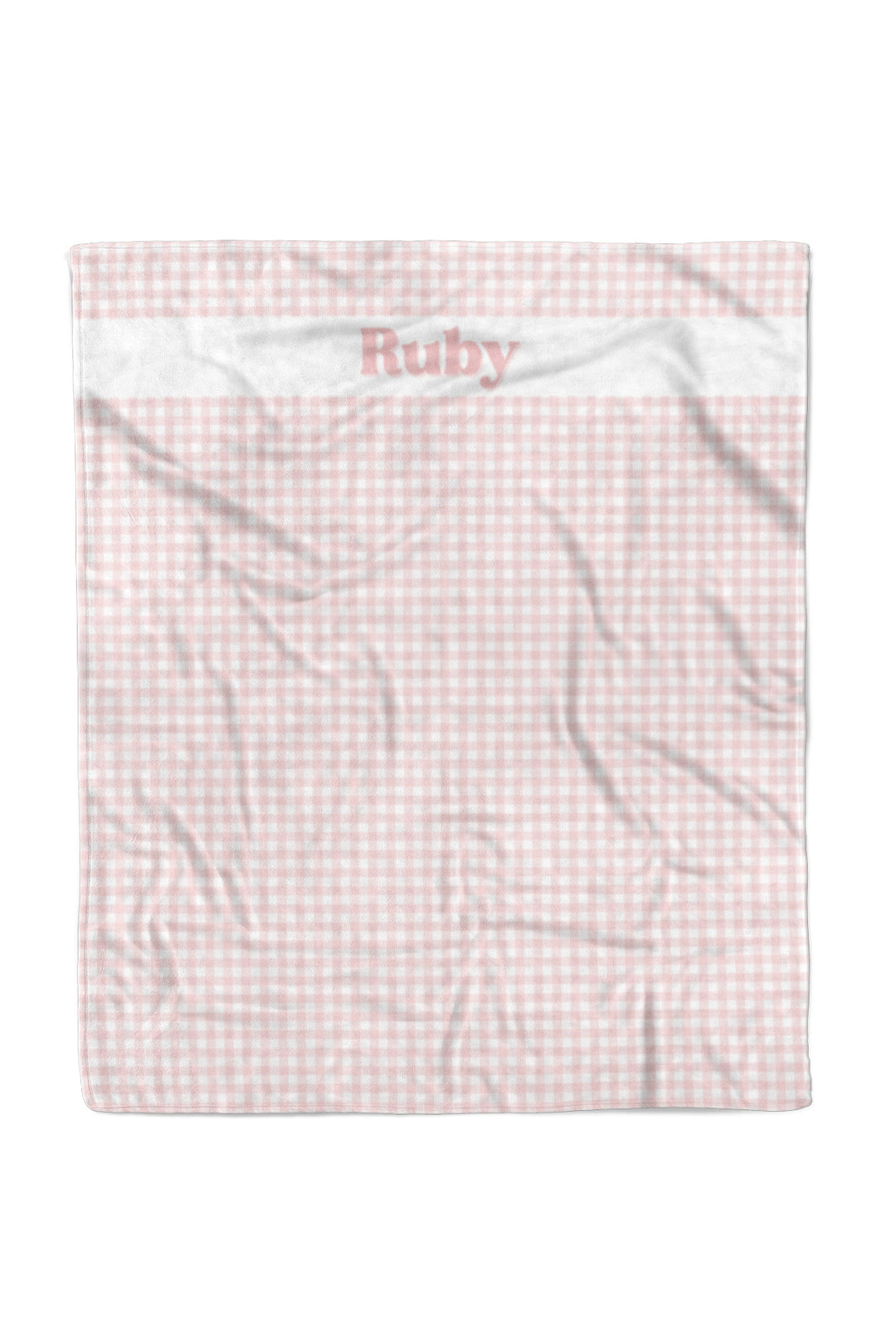A Lane & Leash pet blanket with a light pink and white gingham check pattern, featuring a white top border with the name 'Ruby' embroidered in pink. The blanket is shown wrinkled against a plain white background.