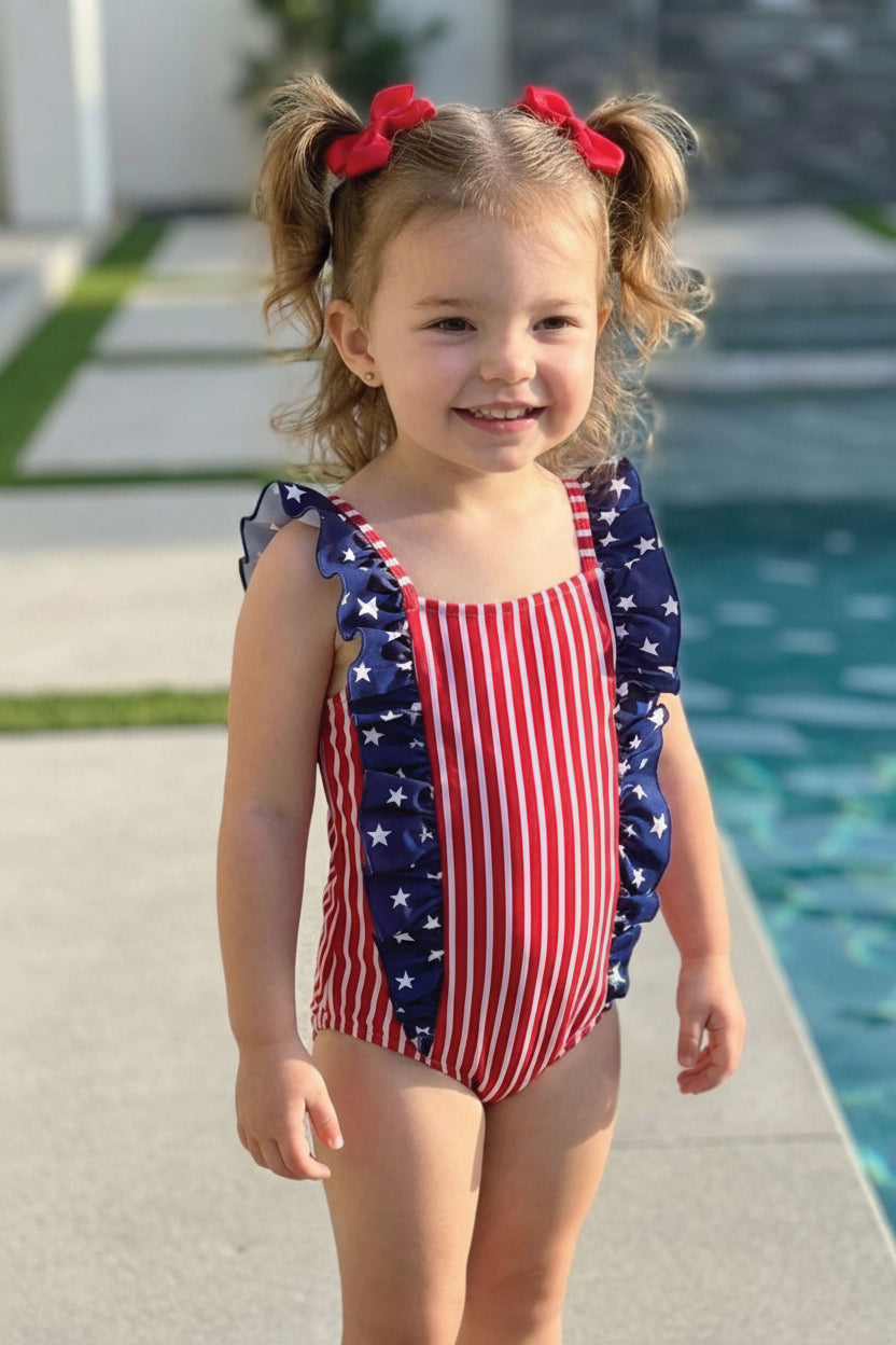 Baby girl double ruffle bow back one piece swimsuit flat lay | 4th of July kids swimwear | patriotic red white blue | Caden Lane