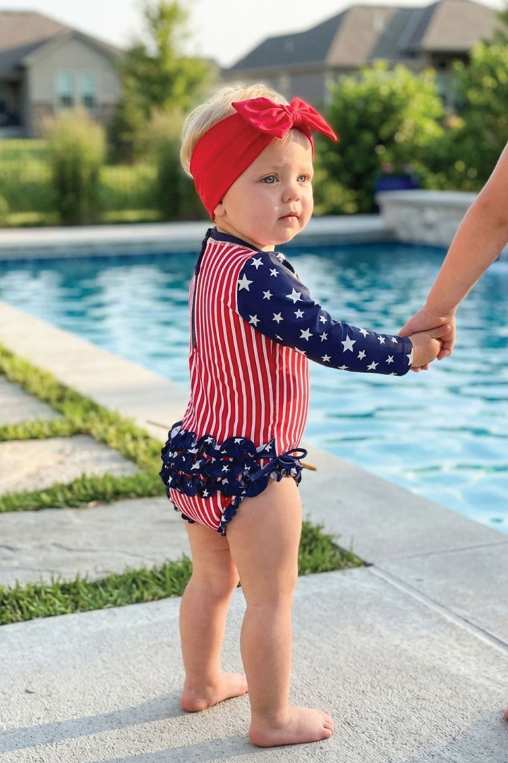 Stars & Stripes Party baby girl rash guard with ruffle bottom detail view 7 | 4th of July kids swim | Caden Lane