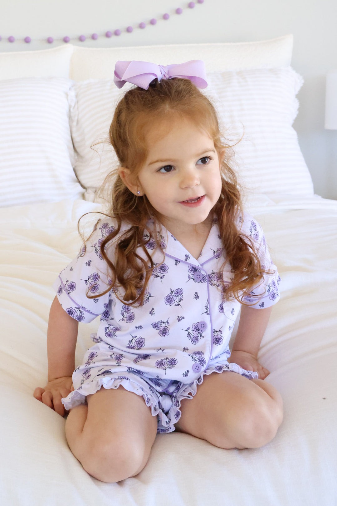 girl kneeling on bed in short sleeve and short lounge set amethyst garden