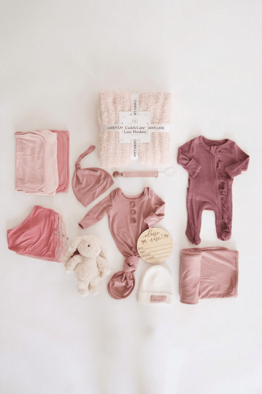 baby shower gift bundle for girls with pink 2pc waffle, zipper footie, knot gown, wood  stats, swaddles, bottle labels, burps, socks, paci clip, beanie, lovey, blanket, hooded towel, hair brush, bunny stuffed animal