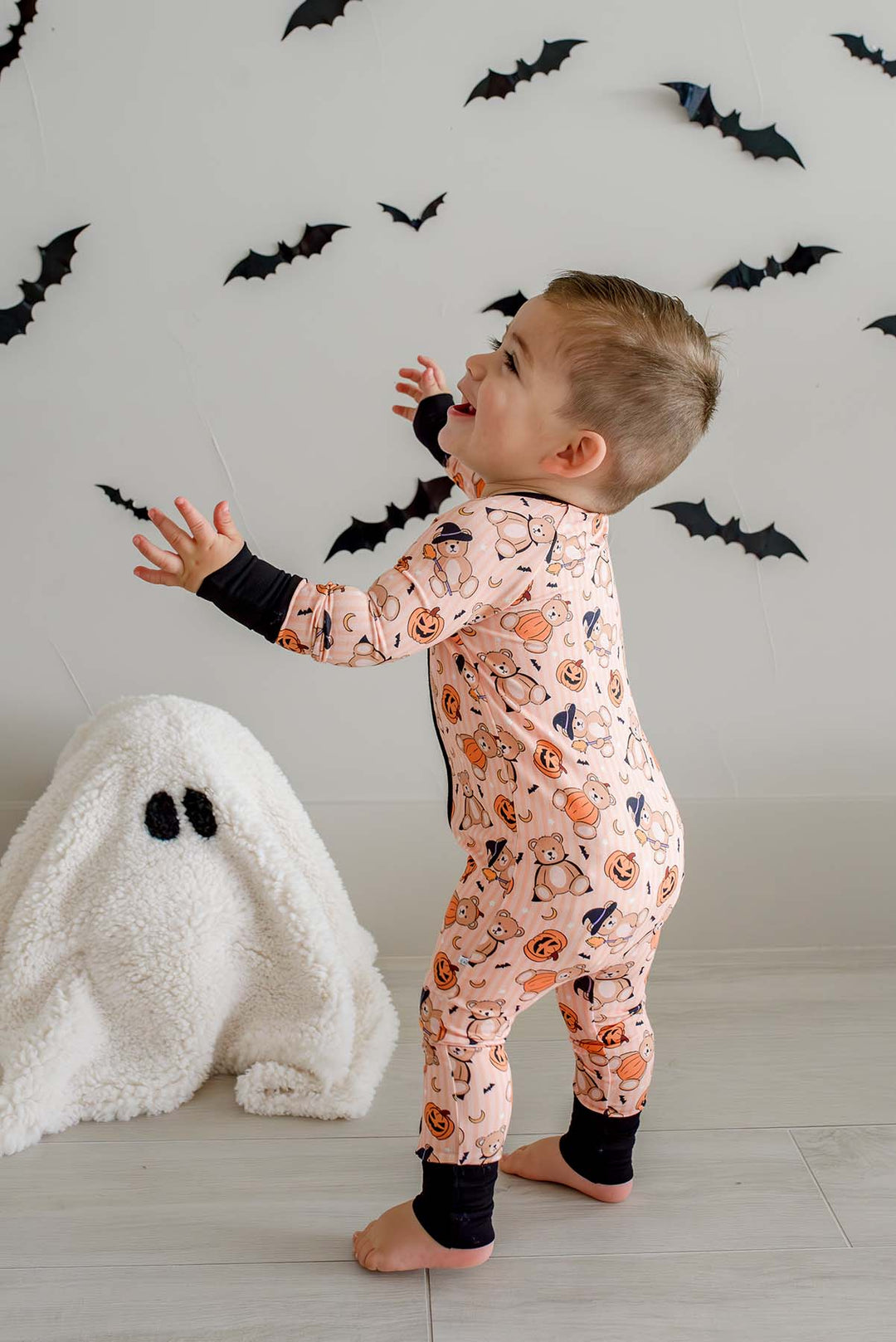 toddler boy smiling in beary scary zip romper