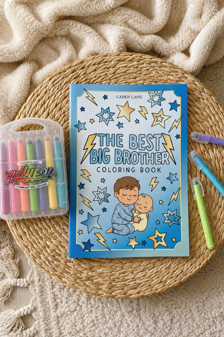 Caden Lane "The Best Big Brother" coloring book in blue with stars and lightning bolts, styled with Gellypop gel crayons on a woven tray.
