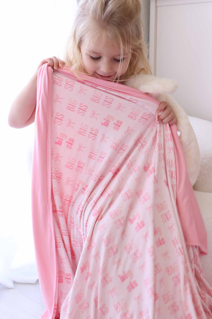 big holding up big sis double sided bamboo blanket in pink 