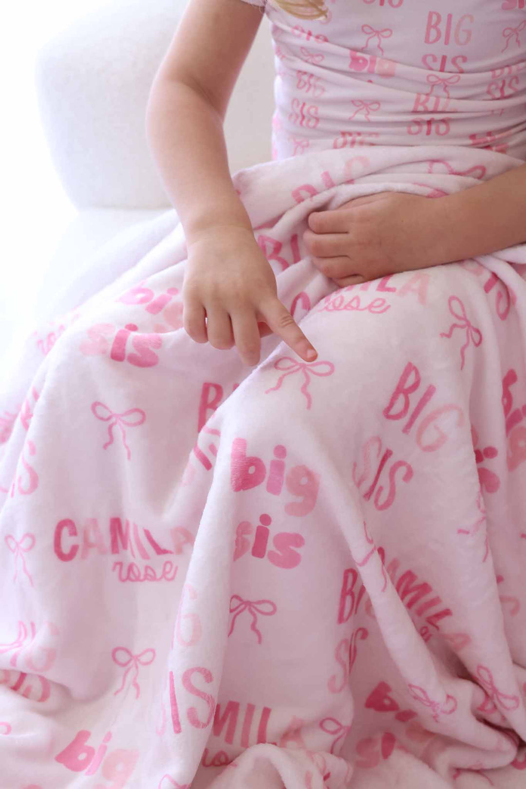 girl with big sis personalized blanket for kids with pink bows on her lap