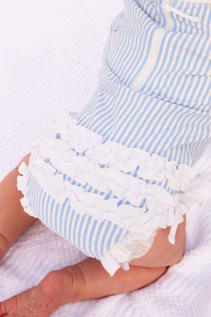 back view of blue seersucker ruffle bottom rash guard swimsuit 