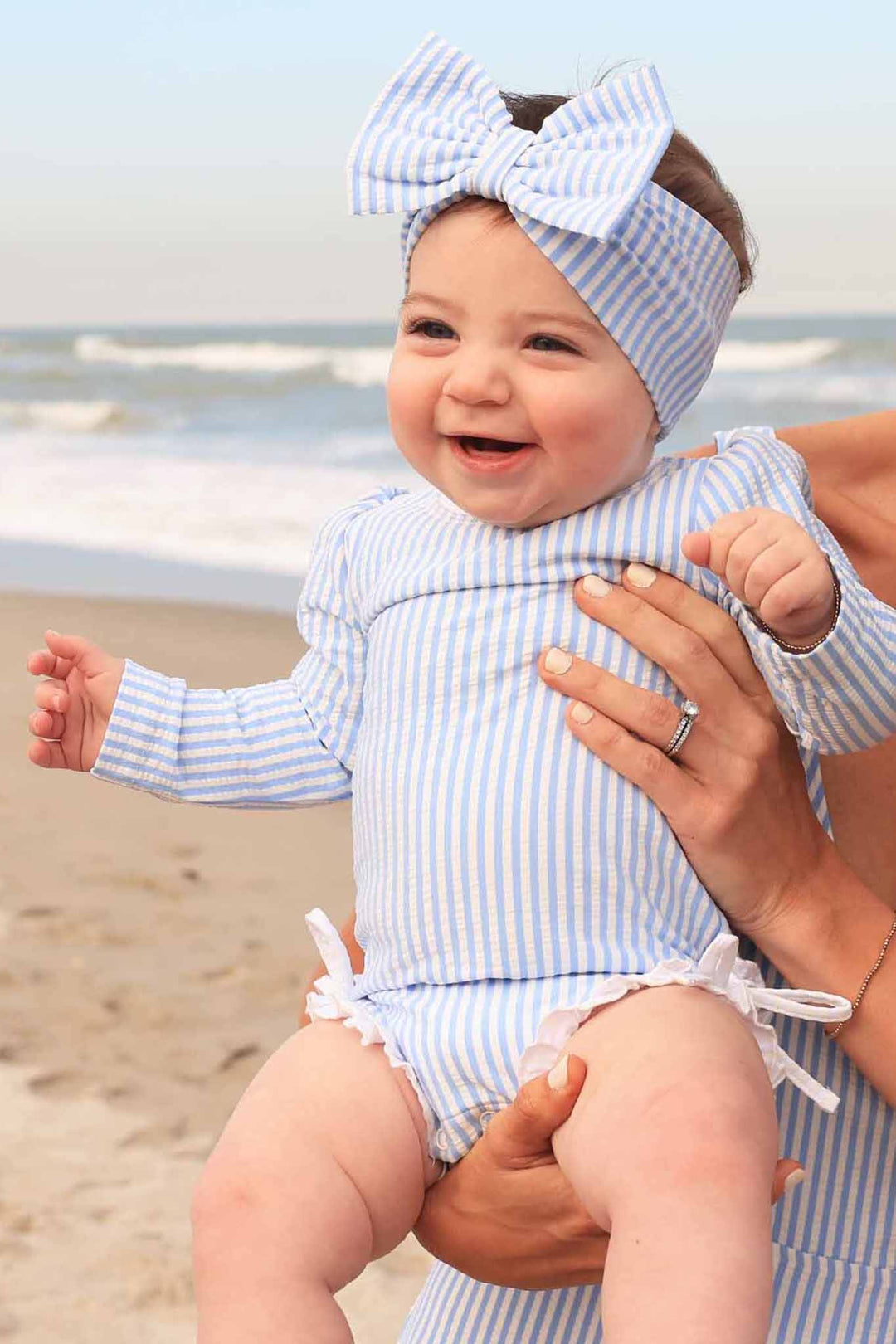 blue seersucker ruffle bottom rash guard swimsuit with matching swim bow 