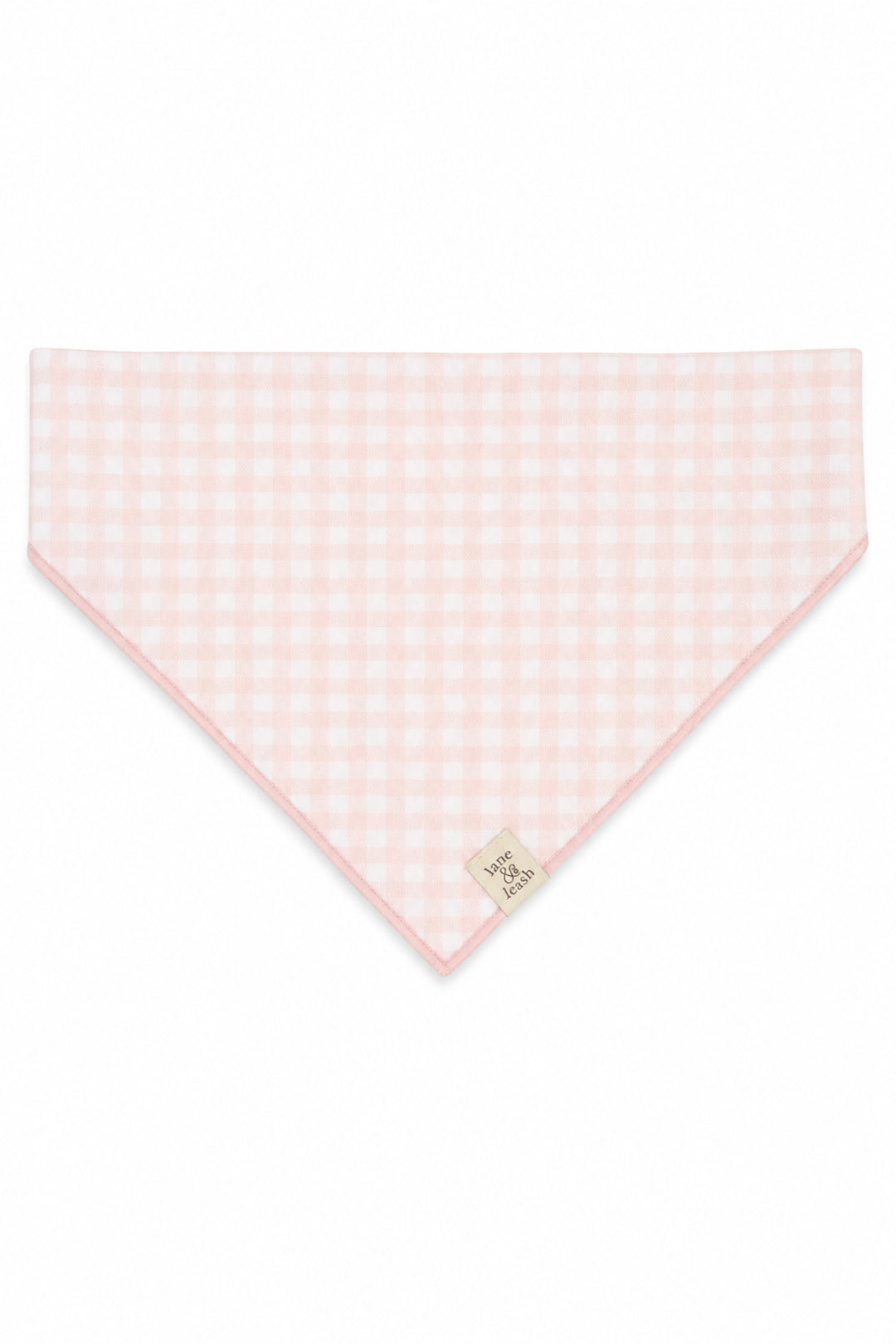 A Lane & Leash light pink and white gingham checkered triangular bandana or pet bandana with a small beige brand tag near the bottom point, displayed flat against a solid white background.