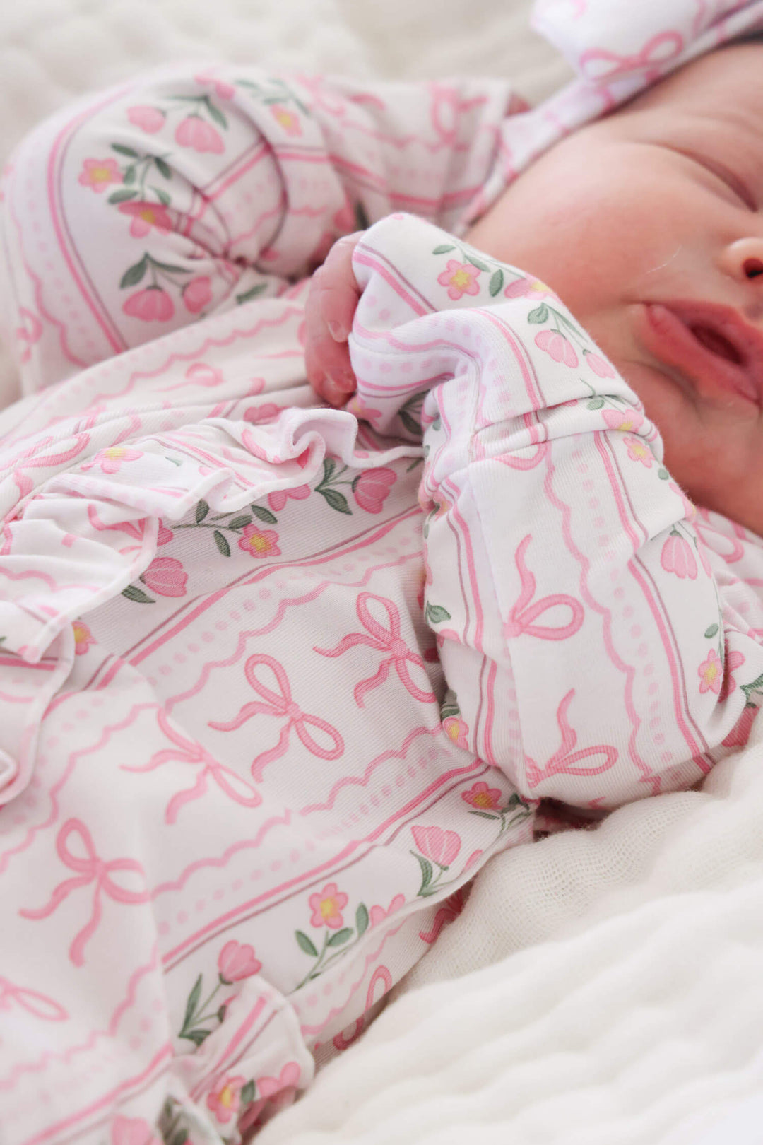 soft bamboo ruffle zipper footie in coquette garden print for babies