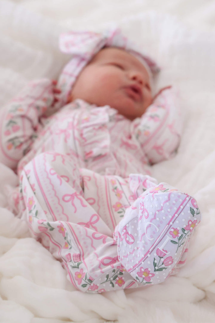 newborn ruffle zipper footie in coquette garden floral and bow print