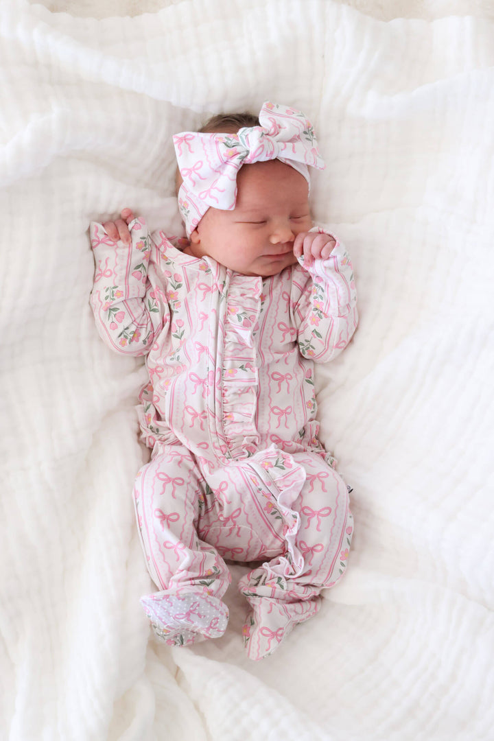 baby ruffle zipper footie featuring coquette garden bows and flowers