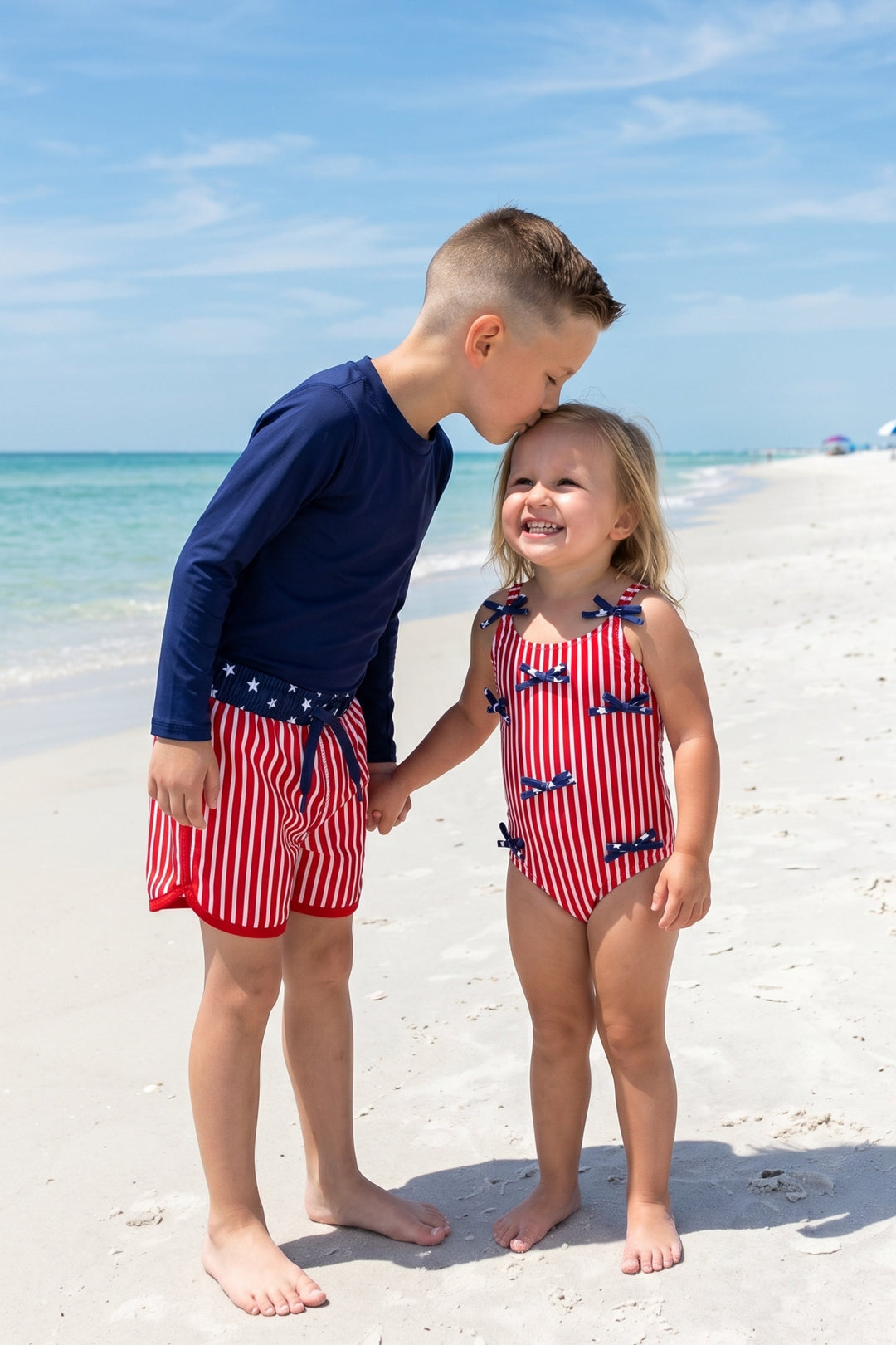 brother and sister at the beach in stars & stripes swimsuits 