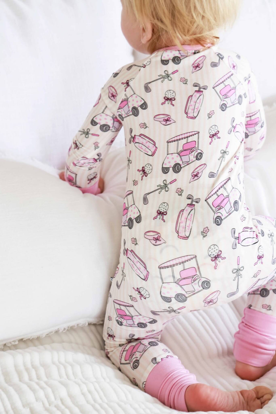 back view of caddie crew pink zip romper