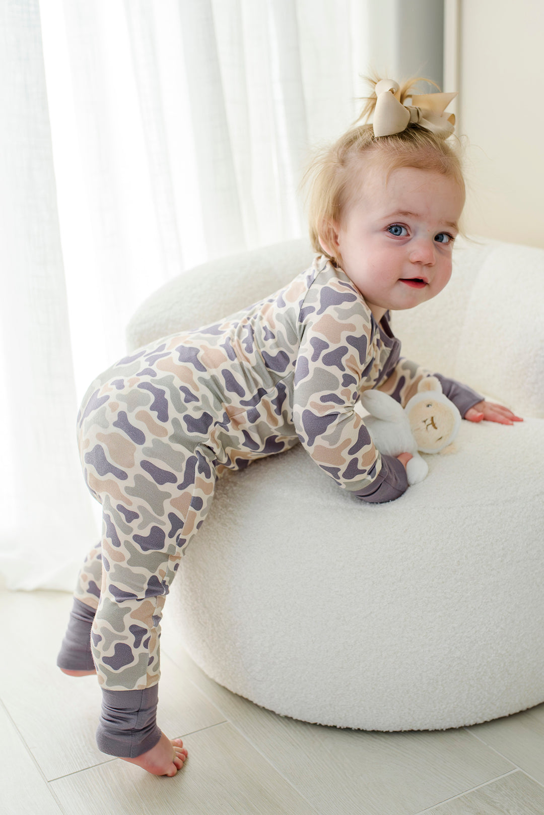 Back view of toddler in camo cutie convertible zip romper with lavender and pink camo print