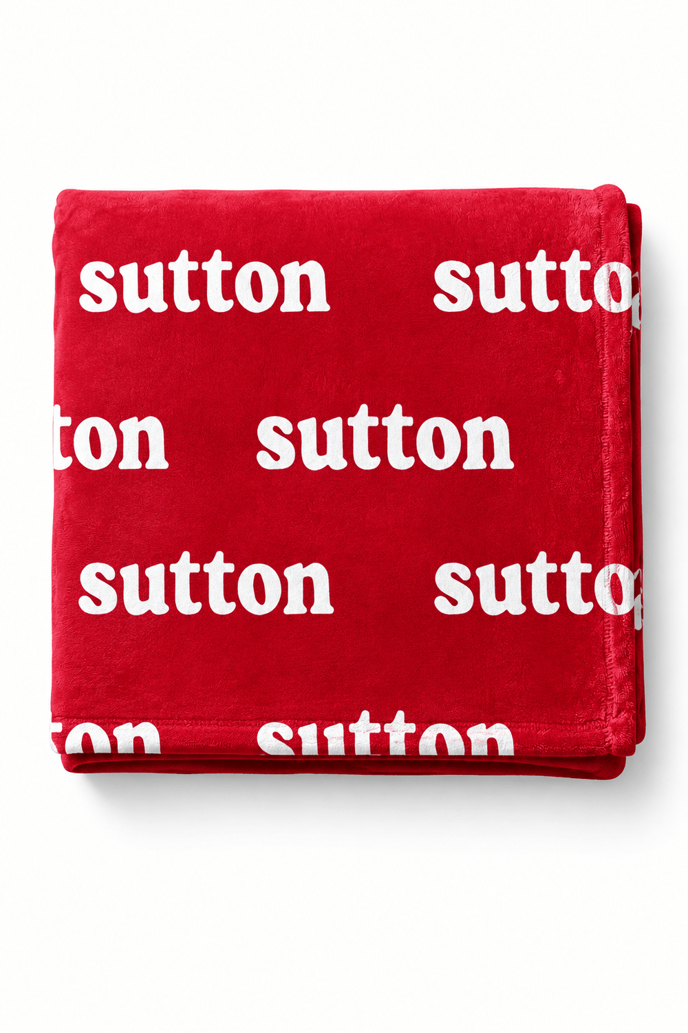 A folded red throw blanket with a repeating white 'sutton' logo print, displayed on a clean white background.
