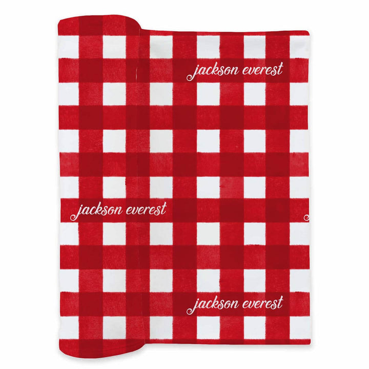 red and white check christmas personalized swaddle blanket with white font 