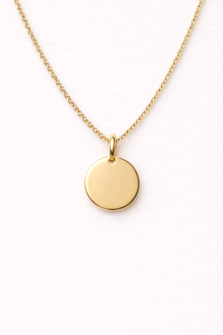 Caden Lane gold curb chain necklace with a blank engravable circle disc pendant