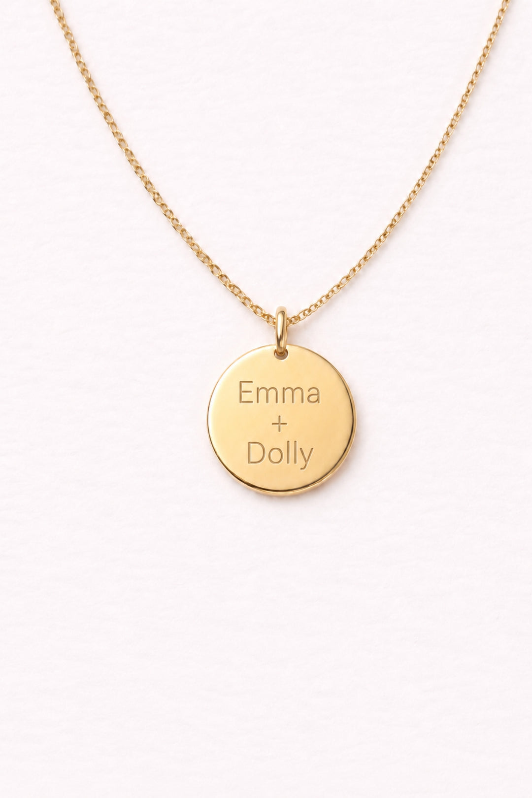 Caden Lane gold necklace with engraved "Emma + Dolly" circle disc pendant