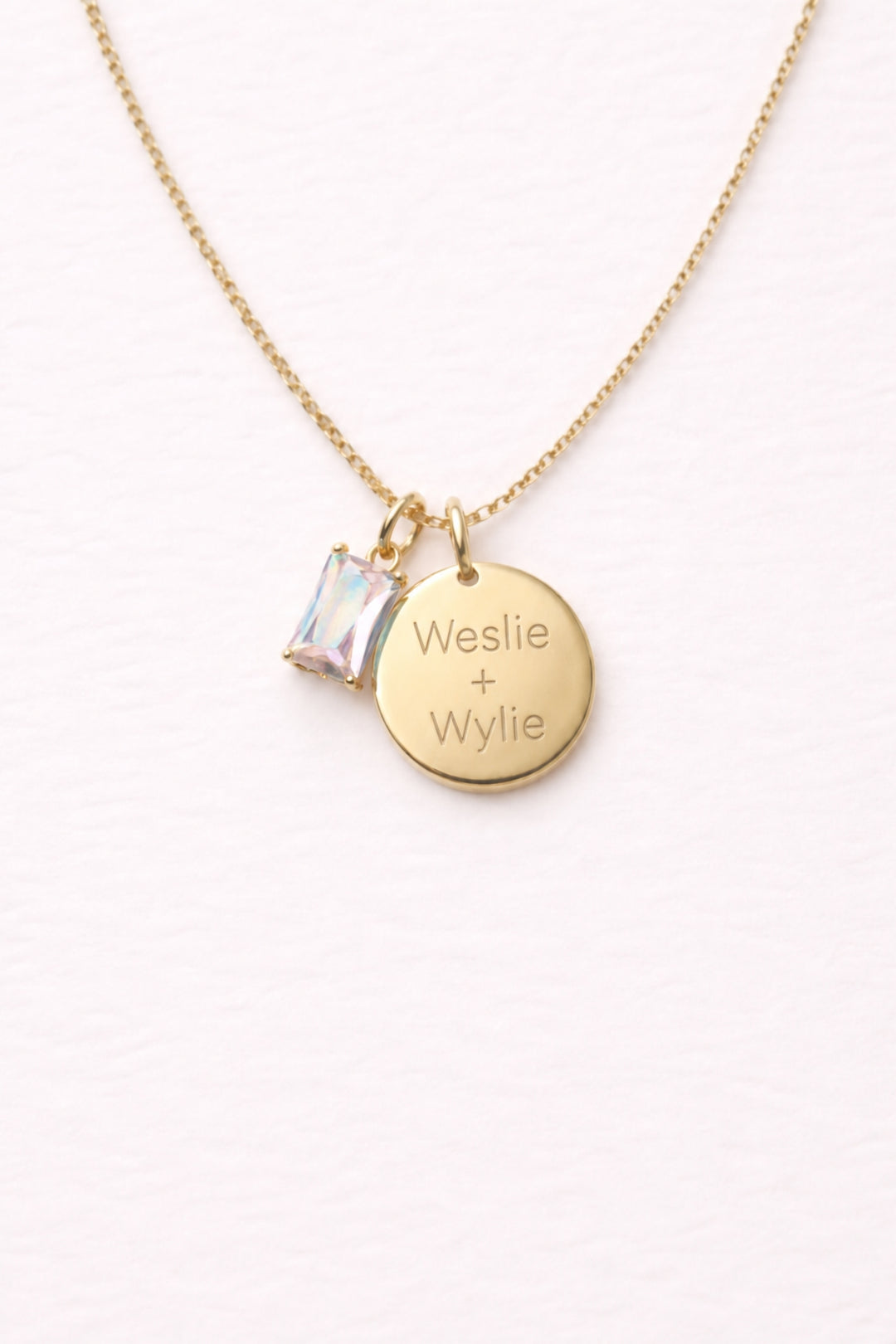 Caden Lane gold necklace with engraved "Weslie + Wylie" circle disc pendant and iridescent birthstone charm