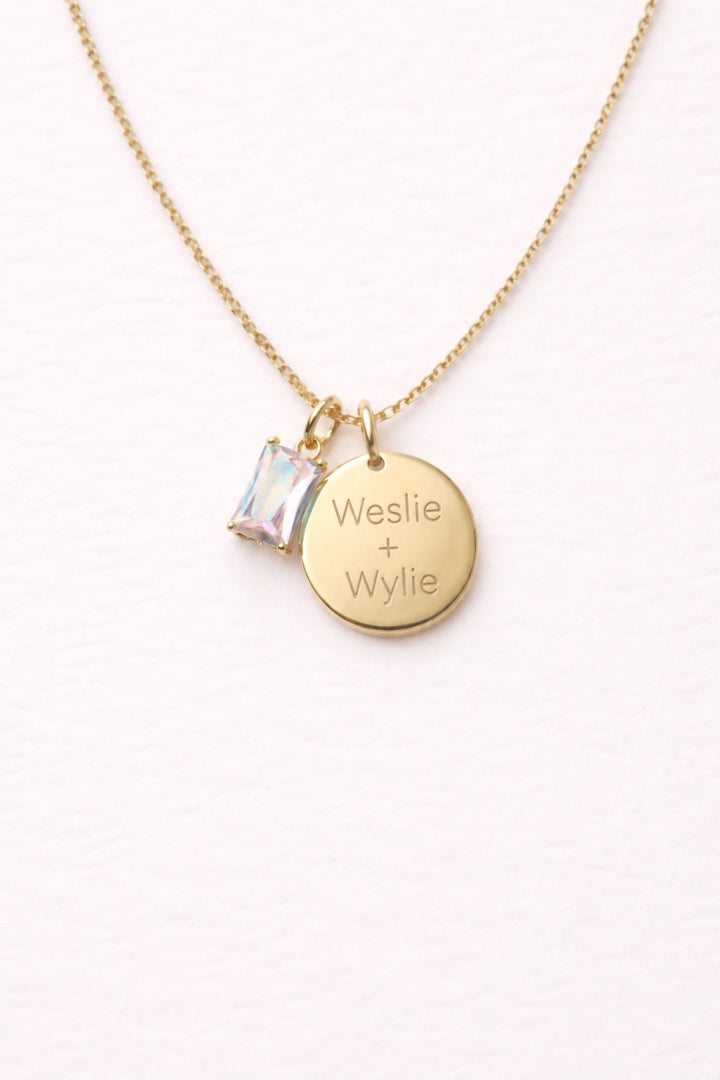 Caden Lane gold necklace with engraved "Weslie + Wylie" circle disc pendant and iridescent birthstone charm